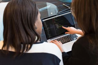Developers hand-coding a website